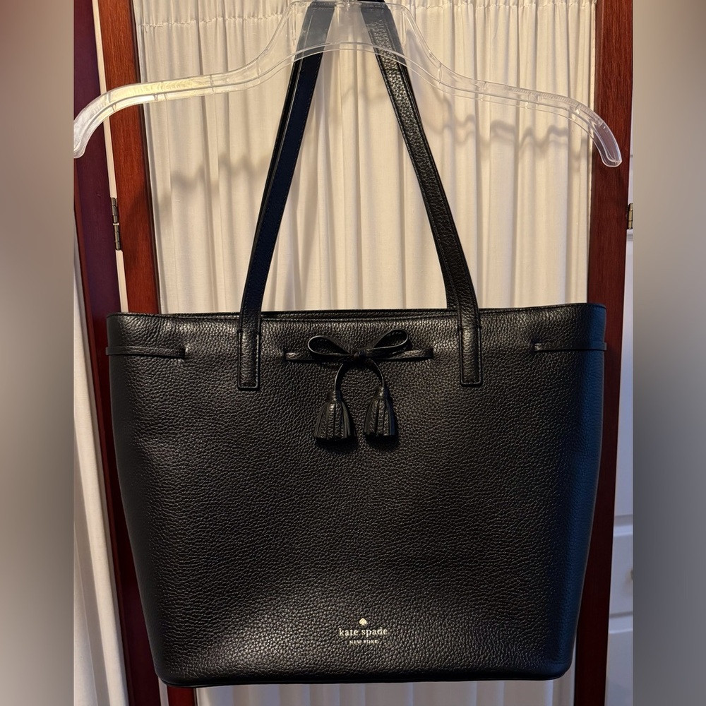 KATE SPADE Hayes Black Pebbled Leather zip top Tote with bow and tassel details.
